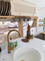 The sink was chosen to accommodate their largest fry pan for dishwashing. Both it and the faucet were sourced from Amazon for $190.