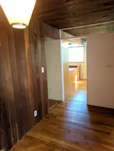 Before: This view shows how the T-wall partitioned the entry from the living spaces and the stairwell, to the left, was enclosed.