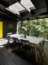 The covered deck has a skylight to bring more natural light into the outdoor area.