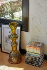 A vintage Murano glass vase sits with a framed etched print from artist Don Corleon.