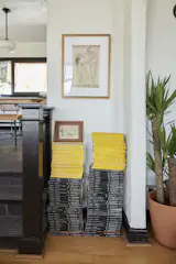 Artful stacks of Caleb’s collection of National Geographic and Monocle magazines. “They make for decoration, but I just like having them around after I read them as well,” says Caleb. Adds Natalie: “I love them because my family's Italian, and my grandma would always have bright yellow pieces that she would decorate with. That was my way to celebrate that part of her home and bring it to our home.” The Lincoln Center poster is vintage, and the couple lived nearby it when they were based in NYC.