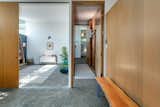 In the principal suite, sliding doors connect the bedroom to a bonus room/potential office.