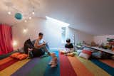 The peek-a-boo window in the attic space helps to connect the family across floors.