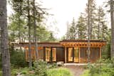 The 570-square-foot cabin has 420 square feet of interior living space and a 150-square-foot screened porch. Cor-Ten steel wraps the building, which also has a planted roof.