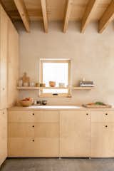 Streamlined birch plywood cabinetry and a maple butcher-block counter forms the kitchenette, which isn’t intended for extensive meal prep. The building is a blend of "a bedroom and camping," says Shaw, which means much of the cooking and cleaning happens outside.