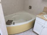 Before: A 90s-era tub speaks to the mishmash of time periods found throughout the apartment.