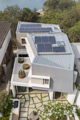 A photovoltaic roof array supplies 92% of the home’s electricity usage, with future plans to increase those capabilities with battery storage. There are also systems for rainwater harvesting and greywater recycling.