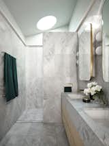 In the main bathroom, Artedomus Elba stone, a honed marble, covers the walls and floor.
