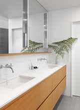 The vanity has VG fir cabinets topped with ‘Pure White’ Caesarstone. The wall-mounted faucets are the Purist line by Kohler.