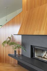 The existing fireplace was re-clad in custom-milled tongue and groove VG fir, and Black Vermont granite with a leathered finish around the firebox.