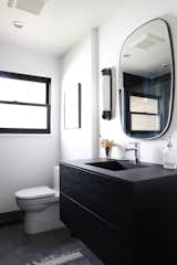 A floating vanity saves space in the petite footprint. Cement tile covers the floor.