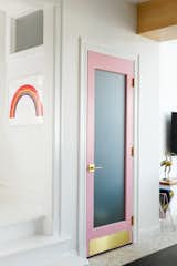 In the Pink, a paint color by Sherwin Williams, highlights the pantry door. Everything else is painted Chantilly Lace by Benjamin Moore. 