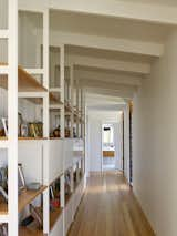 A long, airy hallway lines the guest wing with built-in shelves along the wall and a bathroom at the end of the corridor. The wing can be closed up seasonally when visitors aren’t around as often.