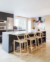The kitchen island is nine-and-a-half feet long, made possible by knocking down non-load-bearing walls and enlarging the room’s footprint. The island is “much larger than what most people would do in that space, because it's not that large of a space, but knocking down those walls and going with a large island makes the kitchen feel a lot more grand,” says Devlin.