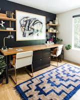 A dramatic black-painted wall is a backdrop for the home office. The renovation has compelled the couple to move into the home full-time and rent their Seattle townhome.