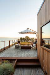 The roof deck, anchored by a gas fire pit from Paloform, boasts an incredible view of the water.