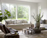 The new living room, with nine-foot ceilings, has generous windows overlooking the backyard.