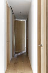 Now, all of the bedrooms open to the reorganized hallway, which also has a laundry area behind the sliding door on the left. The flooring is Virgo engineered wood flooring in Rustic Oak, which creates a soothing consistency throughout.