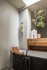 A walnut partition between the bedroom and bath has storage and lets the light from the skylight spread throughout.