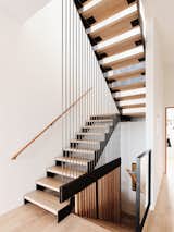 The architects gave the new oak-and-steel staircase pride of place. The stairway leading down goes to the garage level, where the team installed a den and laundry facilities, as well as a full bath for rinsing off after a surf session.