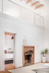 The fireplace was kept as a reminder of the house’s previous form, and its mantle and cladding removed to bare the remaining brick. Then it was framed, “almost like a piece of art on the wall,” says Ruffin. “We wanted to expose some of these old moments.”