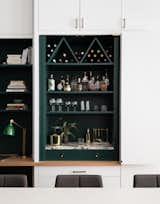 The shelves and the hidden bar are painted a delightful ‘Tarrytown Green’ by Benjamin Moore.