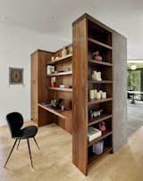 Walnut built-ins store household odds-and-ends, clothing, and create a desk for work.