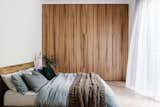 A wall of custom Blackbutt cabinetry forms the closet in the main bedroom, which also has new glass doors to the side yard.
