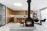 The Paul Agnew cast fireplace sits on a Kyash Cubes concrete plinth, to create definition between the living room, and kitchen and dining zones in the open plan. It being double-sided ensures that it can be enjoyed in the round. Placing the cooktop in the island was a specific request from the client. “They wanted to be able to talk to their guests while they cooked,” says Crisp. “It’s actually a small request that has a surprisingly big effect when entertaining and adds to the drama of the room.”