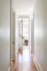 The upstairs hallway now has two bedrooms on one side, and two bathrooms on the other, and ends at the glass door of the study.