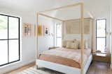 The Thompson Canopy Bed is from Maiden Home, with white oak Jameson nightstands by Faithful Roots. The custom wall hanging is Woven by Ro, and is combined with prints from the Block Shop. The sconces are Circa Lighting’s Lancelot Pivoting Light.