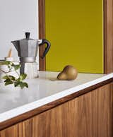 Kitty wanted to keep the peninsula that separates the kitchen from the dining room, as it’s a great prep spot and serving counter. The chartreuse color “feels a little retro, but also fresh today,” says Lin.