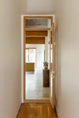 The couple needed a “clear delineation” between the office and home spaces, so this hallway and door demarcates the transition.