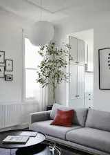 On the other side of the room, the Sabrina couch from Zenith was placed with the Fat-Fat nesting tables by Patricia Urquiola for B&B Italia.