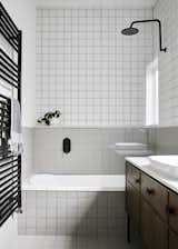 Matte tile in two different colors outfits the bathroom.
