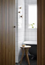 The bathroom has a custom wood surround on the door to prevent sight lines to the toilet.