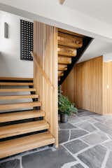The metal skeleton for the staircase was kept, and new white oak tread and a slat wall added.