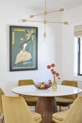 The Trinidad and Tobago tourism poster that kickstarted the design has pride of place. A Rove Concepts table is surrounded by mustard West Elm chairs, and the brass chandelier is from the Florida-based lighting design company, Triple Seven Home.