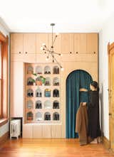 “We wanted to have fun with it,” says Ren of the entry installation. A teal velvet curtain acts as the closet door.