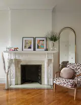 The fireplace was refurbished and one of the owner’s chairs reupholstered in Overpass in Carmine by Wolf Gordon.