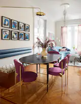 In the new dining room, a custom teak bench with storage and back cushion lines one side of the vintage Paul McCobb table, newly ebonized black. The artwork is the Wax Pencil Art Series by Frank Magnotta.