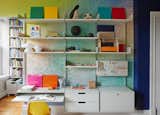 Bright hues and visually intriguing wallpaper add energy to a workspace, making it an excellent office for creatives. This particular wall covering is the Heavens Dondi Colorscape from Flat Vernacular. Pair the eye-catching pigments with neutral built-in modular shelving—like this Vitsoe unit—to keep clutter to a minimum and change the arrangement as needed.