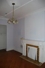 Before: The fireplace was kept intact, along with other historic details like the inlaid floors.