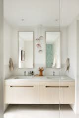 A refinished bathroom with a Bocci 84.5 Pendant is a retreat for the parents.