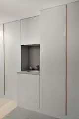 Closets, coat hooks, and wine storage are stowed behind the mudroom doors. The handwashing station has Caesarstone ‘Raw Concrete’ counter and backsplash (and was a fortuitous installation before the pandemic.)