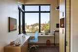 A new office is wreathed in custom cabinetry, as well as a sitting and standing desk, and relishes the views. A pocket door fashioned after a Shoji screen enables privacy.
