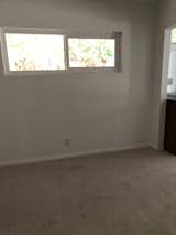 Before: The primary bedroom was fairly standard, with a high window that allows a bed to be placed beneath it.
