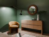 The Cortez Natural Floating Dresser by Leanne Ford from Crate &amp; Barrel was placed with a vintage chair and sconce from West Elm.