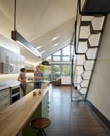 One of Taryn’s favorite new features is the kitchen island, which acts as prep counter, has seating, and an inset wine rack, and was designed by Mickus, who also designed and fabricated the linear pendant overhead.