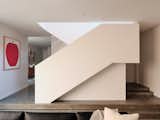 “It’s almost like a piece of sculpture,” the homeowner says of the staircase. Polished concrete floors have radiant heating.